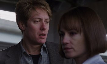 Movie still from “Crash” (1996), directed by David Cronenberg – A man and a woman looking at one another; Close Up shot, Over the shoulder angle