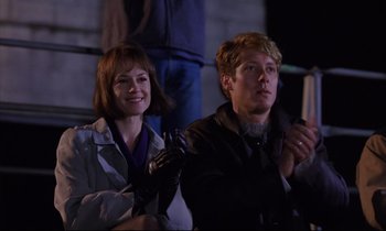 Movie still from “Crash” (1996), directed by David Cronenberg – A man and a woman sitting next to each other; Medium shot, Low angle