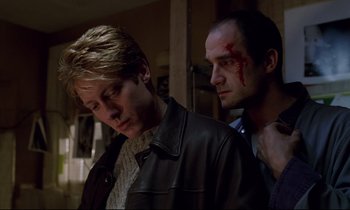 Movie still from “Crash” (1996), directed by David Cronenberg – Two men with blood on their faces and one is bleeding; Close Up shot, Low angle