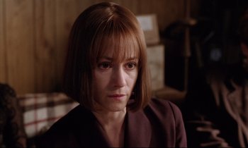 Movie still from “Crash” (1996), directed by David Cronenberg – A person with short brown hair; Close Up shot, High angle