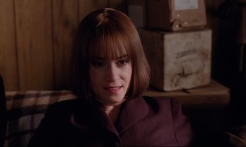 Movie still from “Crash” (1996), directed by David Cronenberg – A person sitting in a room; Close Up shot, High angle