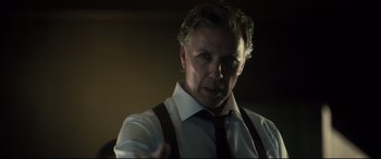 Movie still from “The Girl in the Spider's Web” (2018), directed by Fede Alvarez – A person wearing a shirt and tie; Close Up shot, Over the shoulder angle