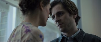 Movie still from “The Girl in the Spider's Web” (2018), directed by Fede Alvarez – A man and a woman face to face in front of each other; Close Up shot, Low angle