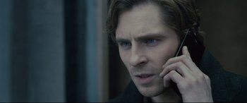 Movie still from “The Girl in the Spider's Web” (2018), directed by Fede Alvarez – A person talking on a cell phone; Close Up shot, Over the shoulder angle