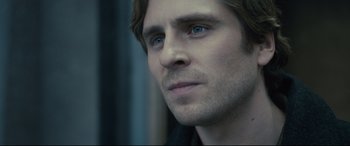 Movie still from “The Girl in the Spider's Web” (2018), directed by Fede Alvarez – A man's face with blue eyes; Close Up shot, Over the shoulder angle