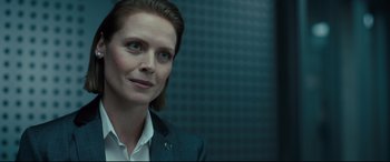 Movie still from “The Girl in the Spider's Web” (2018), directed by Fede Alvarez – A person wearing a suit and tie; Close Up shot, Over the shoulder angle