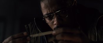 Movie still from “The Girl in the Spider's Web” (2018), directed by Fede Alvarez – A person wearing glasses and holding a stick; Close Up shot, Low angle