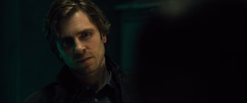 Movie still from “The Girl in the Spider's Web” (2018), directed by Fede Alvarez – A person wearing a black shirt; Close Up shot, Over the shoulder angle