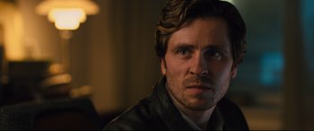 Movie still from “The Girl in the Spider's Web” (2018), directed by Fede Alvarez – A person wearing a leather jacket; Close Up shot, Over the shoulder angle