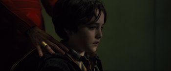Movie still from “The Girl in the Spider's Web” (2018), directed by Fede Alvarez – A young boy with his hand on his shoulder; Close Up shot, Over the shoulder angle