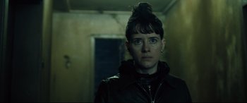 Movie still from “The Girl in the Spider's Web” (2018), directed by Fede Alvarez – A woman in a leather jacket looking at the camera; Close Up shot, Low angle