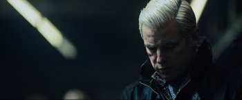 Movie still from “The Girl in the Spider's Web” (2018), directed by Fede Alvarez – A person wearing a black jacket; Close Up shot, Over the shoulder angle