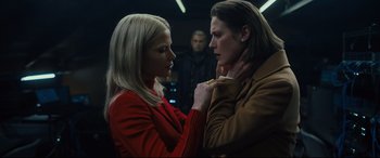 Movie still from “The Girl in the Spider's Web” (2018), directed by Fede Alvarez – Two women are looking at each other in a dark room; Medium shot, Low angle