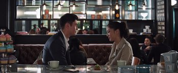 Movie still from “Crazy Rich Asians” (2018), directed by Jon M. Chu – A man and a woman sitting at a restaurant table; Medium shot, Over the shoulder angle