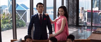 Movie still from “Crazy Rich Asians” (2018), directed by Jon M. Chu – A man and a woman in formal wear standing next to each other; Medium shot, Low angle