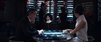 Movie still from “Crazy Rich Asians” (2018), directed by Jon M. Chu – A man sitting at a table in front of a mirror; Medium shot, Over the shoulder angle