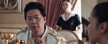 Movie still from “Crazy Rich Asians” (2018), directed by Jon M. Chu – A man and a woman in formal wear in front of a window; Close Up shot, Over the shoulder angle