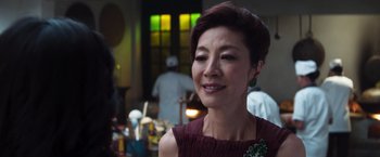 Movie still from “Crazy Rich Asians” (2018), directed by Jon M. Chu – A person wearing a dress; Close Up shot, Over the shoulder angle