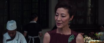 Movie still from “Crazy Rich Asians” (2018), directed by Jon M. Chu – A person wearing a dress; Close Up shot, Over the shoulder angle