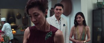 Movie still from “Crazy Rich Asians” (2018), directed by Jon M. Chu – A man and a woman standing next to each other in a room; Close Up shot, Over the shoulder angle