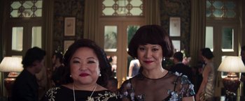Movie still from “Crazy Rich Asians” (2018), directed by Jon M. Chu – A couple of women standing next to each other in a room; Close Up shot, Low angle
