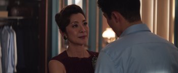 Movie still from “Crazy Rich Asians” (2018), directed by Jon M. Chu – An older woman and a young man are talking; Close Up shot, Over the shoulder angle
