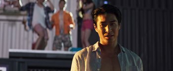 Movie still from “Crazy Rich Asians” (2018), directed by Jon M. Chu – A man in a white button up shirt; Close Up shot, Low angle