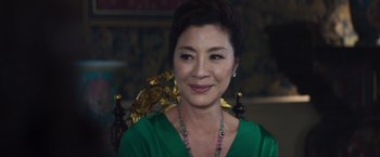 Movie still from “Crazy Rich Asians” (2018), directed by Jon M. Chu – A person wearing a green shirt; Close Up shot, Over the shoulder angle
