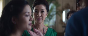 Movie still from “Crazy Rich Asians” (2018), directed by Jon M. Chu – A person wearing a green shirt; Close Up shot, Over the shoulder angle