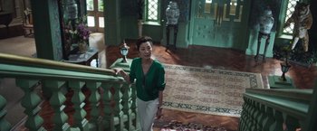Movie still from “Crazy Rich Asians” (2018), directed by Jon M. Chu – A woman standing on the stairs of a house; Wide shot, High angle