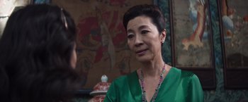 Movie still from “Crazy Rich Asians” (2018), directed by Jon M. Chu – An older asian woman wearing a green shirt; Close Up shot, Over the shoulder angle