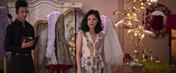 Movie still from “Crazy Rich Asians” (2018), directed by Jon M. Chu – A woman standing in front of a mirror in a room; Medium shot, Low angle