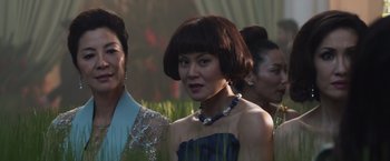 Movie still from “Crazy Rich Asians” (2018), directed by Jon M. Chu – A group of women standing next to each other; Close Up shot, Over the shoulder angle