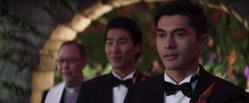 Movie still from “Crazy Rich Asians” (2018), directed by Jon M. Chu – A group of young men in tuxedos standing next to each other; Close Up shot, Over the shoulder angle