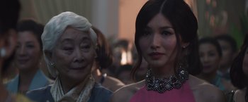 Movie still from “Crazy Rich Asians” (2018), directed by Jon M. Chu – A woman and an old woman standing next to each other; Close Up shot, Over the shoulder angle