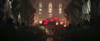 Movie still from “Crazy Rich Asians” (2018), directed by Jon M. Chu – A group of people standing in front of stained glass windows in a church; Extreme Wide shot, Low angle