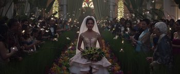 Movie still from “Crazy Rich Asians” (2018), directed by Jon M. Chu – A woman in a wedding dress holding a bouquet of flowers in front of a crowd; Wide shot, Over the shoulder angle