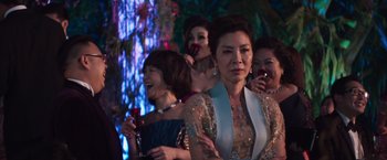 Movie still from “Crazy Rich Asians” (2018), directed by Jon M. Chu – A group of women standing next to each other in a room; Medium shot, Over the shoulder angle