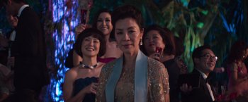 Movie still from “Crazy Rich Asians” (2018), directed by Jon M. Chu – A group of women standing next to each other; Medium shot, Over the shoulder angle