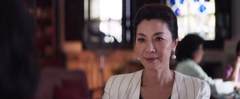 Movie still from “Crazy Rich Asians” (2018), directed by Jon M. Chu – A person wearing a jacket; Close Up shot, Over the shoulder angle