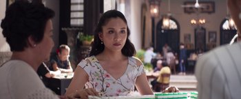 Movie still from “Crazy Rich Asians” (2018), directed by Jon M. Chu – A woman sitting at a table in front of a laptop; Close Up shot, Over the shoulder angle