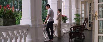 Movie still from “Crazy Rich Asians” (2018), directed by Jon M. Chu – A man and a woman standing next to each other; Wide shot, Low angle
