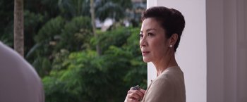 Movie still from “Crazy Rich Asians” (2018), directed by Jon M. Chu – A person holding a cell phone; Close Up shot, Low angle