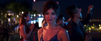 Movie still from “Crazy Rich Asians” (2018), directed by Jon M. Chu – A beautiful young woman wearing a blue dress; Close Up shot, Over the shoulder angle