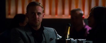 Movie still from “Crazy, Stupid, Love.” (2011), directed by Glenn Ficarra – A person holding a bottle of champagne; Close Up shot, Over the shoulder angle