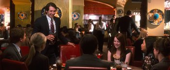 Movie still from “Crazy, Stupid, Love.” (2011), directed by Glenn Ficarra – A group of people sitting at a table in a restaurant; Medium shot, Over the shoulder angle