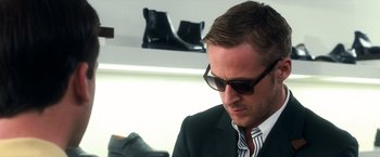 Movie still from “Crazy, Stupid, Love.” (2011), directed by Glenn Ficarra – A person wearing a suit and sunglasses; Close Up shot, Over the shoulder angle