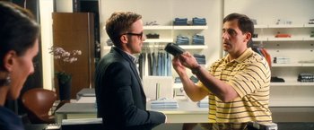 Movie still from “Crazy, Stupid, Love.” (2011), directed by Glenn Ficarra – A man in a suit is being interviewed by a store employee; Medium shot, Over the shoulder angle