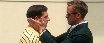 Movie still from “Crazy, Stupid, Love.” (2011), directed by Glenn Ficarra – A man adjusting another man's neck tie in front of a wall; Close Up shot, Over the shoulder angle