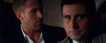 Movie still from “Crazy, Stupid, Love.” (2011), directed by Glenn Ficarra – Two men are looking at the camera in a dark room; Close Up shot, Over the shoulder angle